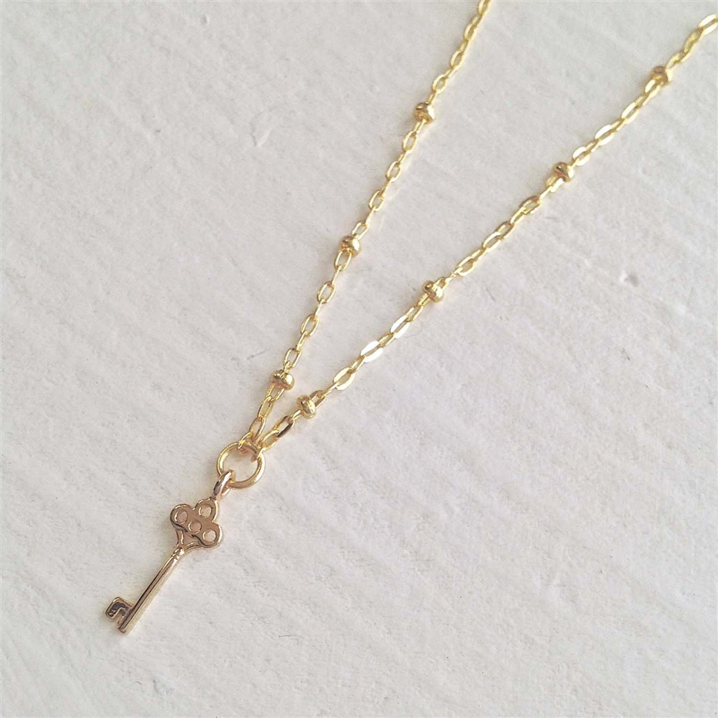 Minerva Tiny Key Charm Gold Necklace