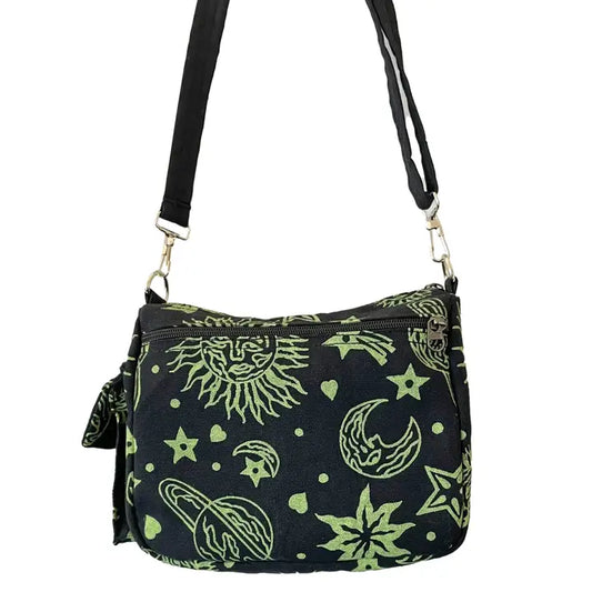 A black crossbody bag featuring a green celestial design depicting suns, moons, stars, and planets