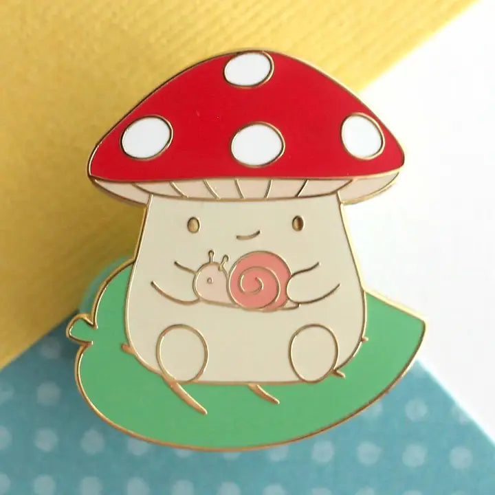 Mushroom On Leaf and Holding A Snail Enamel Pin